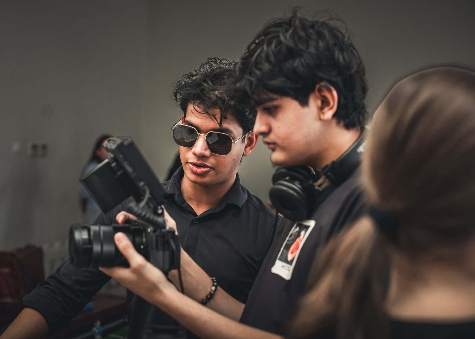 Two crew members check a shot on a cinema camera