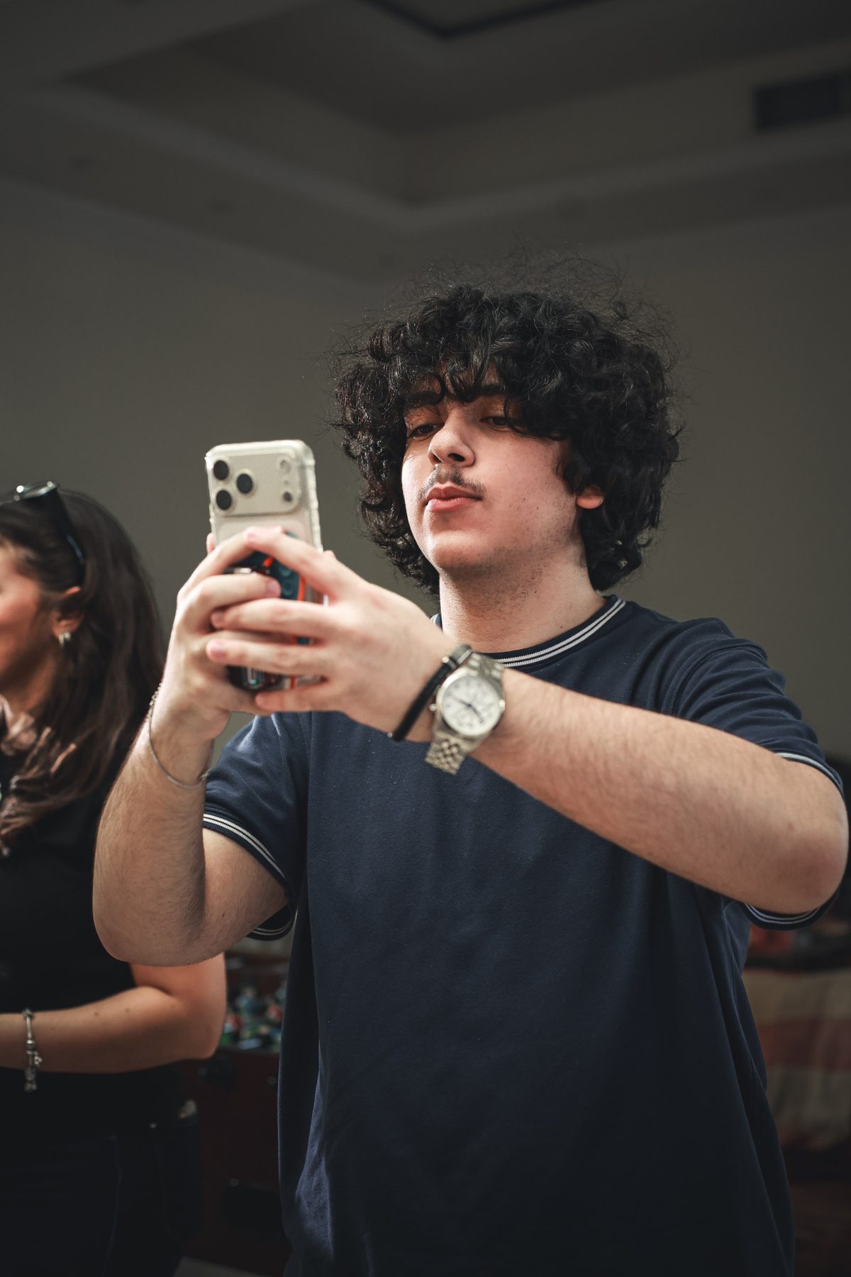 Crew member films behind the scenes on a phone