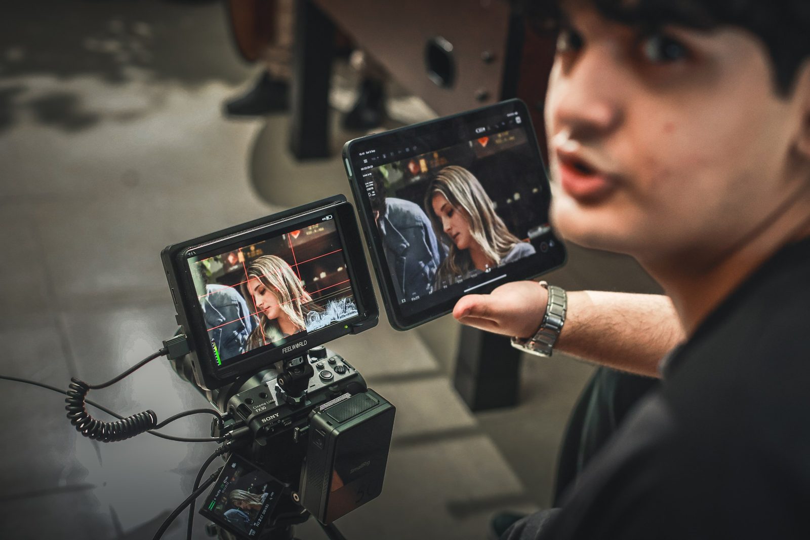 Crew member reviews playback on a field monitor